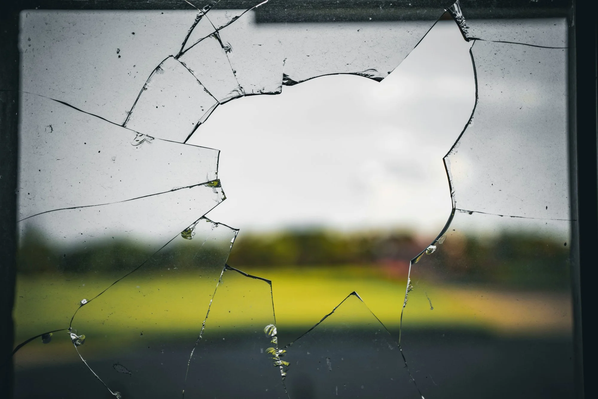 Broken window with cracks radiating outward